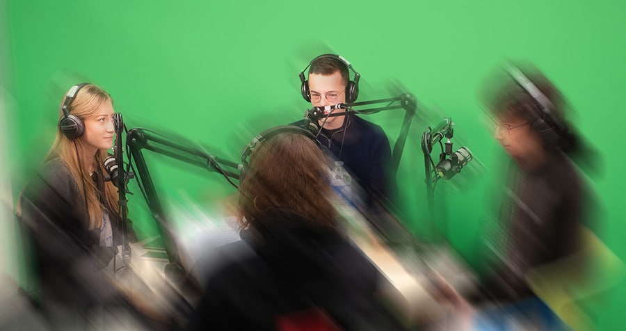 quatre étudiants dans un studio audiovisuel de communication